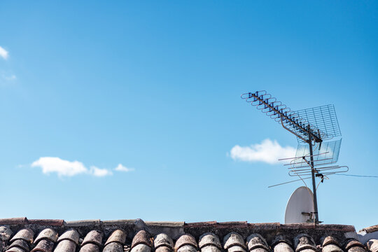 Rooftop with television antenna and satellite dish