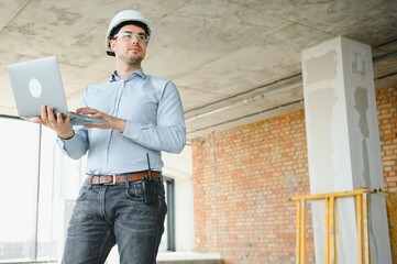 Supervisor using laptop at construction site