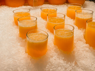 fresh orange juice with pulp in glasses cooled in ice 