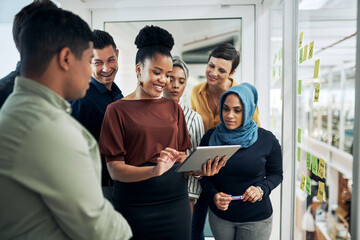 Obraz premium Planning, tablet and business people by glass wall in office with research for journalism. Brainstorming, digital technology and copywriters with information for creative project at magazine agency.