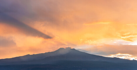 beautiful panorama of volcano mountain during evening synset with twilight clouds and shadows above majectic mountain and amazing cloudy sunset sky on background