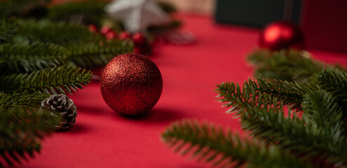 Red Christmas background, Closeup image of fir branches with balls