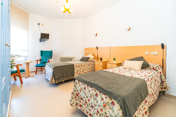 Empty room of a nursing home with two beds