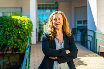 Manager of a nursing home standing proud outdoors