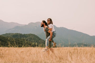 A joyful couple shares happiness in a vibrant field, radiating love and contentment amidst natures...