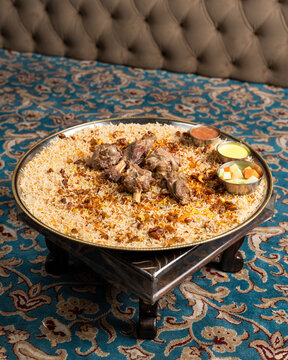 Arabian assorted grill mandi chicken displayed on a big stainless steel plate