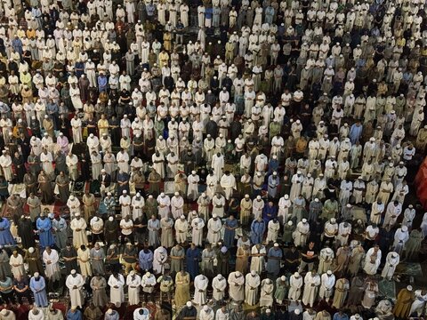 Drone shot of people standing and praying at Masjid al-Haram