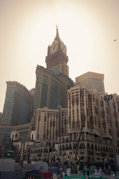 Low angle view of people walking in front of The Clock Towers in Riyadh city