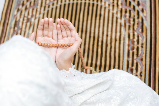 Woman praying on a mat