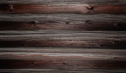 Obraz premium Dark, rustic wooden wall composed of long, horizontal wood panels.
