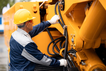 Hydraulic engineer doing safety check on new installation hoses of modern drilling industrial...