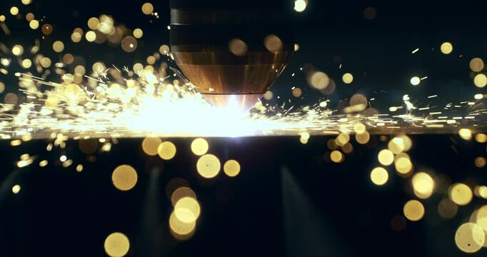 Super slow motion macro of maintenance worker or welder using high-tech industrial welding machine to weld metal steel with flying sparks in workshop or factory setting at 1000 fps.