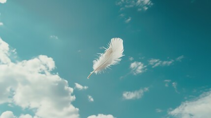 A solitary white feather in mid-air against a vivid blue sky, with a sense of tranquility
