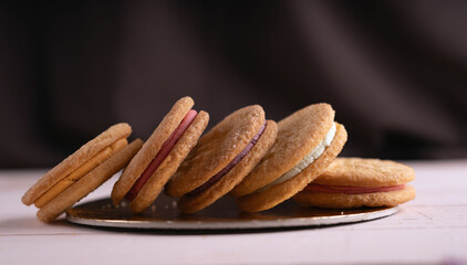 photo, dessert, assortment, sweet, feature, collection, cream, sandwich, cookie, round, texture, color, filling, gourmet, presentation, pink, purple, white, display, tilted, row, reflective, surface