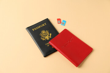 Modern SIM cards and passport on beige background