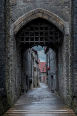 medieval Castle gates leading to an old street, Wales UK