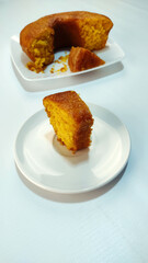 Piece of brazilian cornmeal cake on the white background. This is a Typical food from minas gerais.
