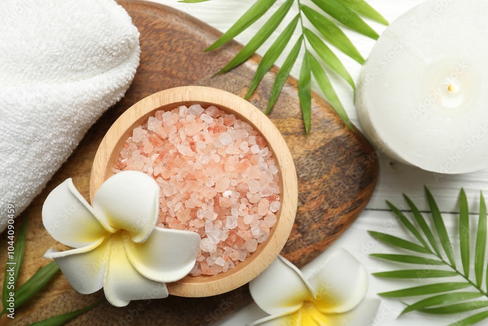 Poster Spa composition with sea salt, plumeria flowers and burning candle on white wooden table, flat lay