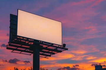 Marketing billboard mockup featuring a blank exterior sign against a sunset sky