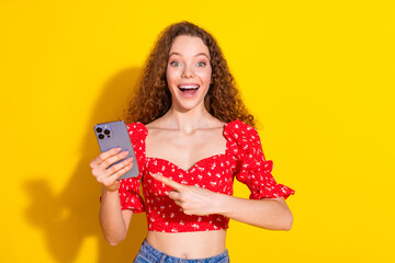 Photo of attractive young woman hold point device iphone pro max excited dressed stylish red...