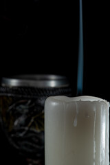 Unlit candles, scene with various objects and recently extinguished candles. Selective focus.