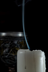 Unlit candles, scene with various objects and recently extinguished candles. Selective focus.