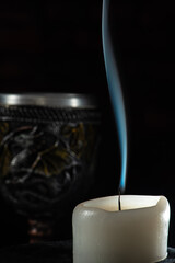 Unlit candles, scene with various objects and recently extinguished candles. Selective focus.
