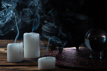 Unlit candles, scene with various objects and recently extinguished candles. Selective focus.