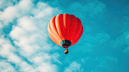 Fototapeta premium Vibrant Hot Air Balloon Against a Blue Sky