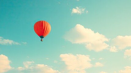 Obraz premium Hot Air Balloon in Clear Blue Sky with Clouds