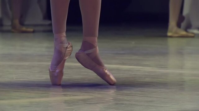 Ballerinas on the Stage. Feet in pointe dancing ballerinas on the stage. Slow Motion