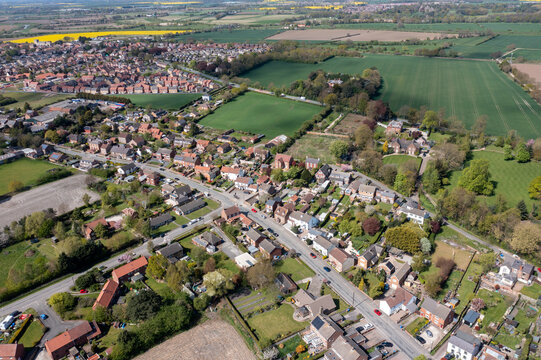 Aerial drone photo of the village of West Cowick in Goole in the East Riding of Yorkshire England showing the streets and houses and homes in the British village in the summer time