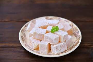 plate with Turkish delight oriental dessert on the table close-up