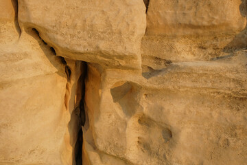 Abstract patterns, shapes and textures of natural cracks on the limestone surface.Natural pattern and texture background. Copy space..For graphic design or banner background.Limestone wall on the edge