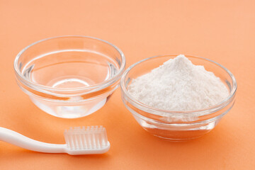 Toothbrush, baking soda and water for oral hygiene.