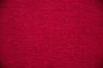 Red fabric backdrop.