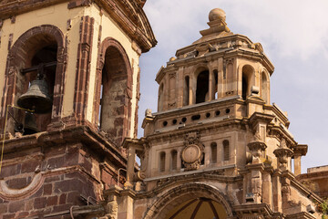 Fototapeta premium Zamora, Michoacán, Mexico - December 24, 2023: Afternoon light shines on a historic church in the heart of downtown Zamora.