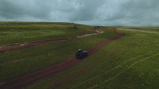 Aerial photography of car movement in the mountains, SUV driving on a mountain road, aerial photography of a road in the North Caucasus, aerial photography of a road in the mountains, lada niva travel