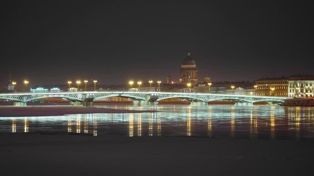 Saint Petersburg, Russia - Feb 06 2021, 4k, Panoramic view of Neva River in winter, in background the Annunciation Bridge and St. Isaac's Cathedral with illumination, at night, St Petersburg, Russia 