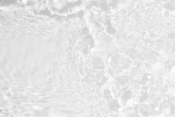 White water with ripples on the surface. Defocus blurred transparent white colored clear calm water surface texture with splashes and bubbles. Water waves with shining pattern texture background.