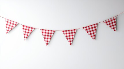 red and white pennants in the shape of a triangle hanging on a light wall background or isolated on a white background with a pennant on a string hanging. Party, birthday or holiday theme

