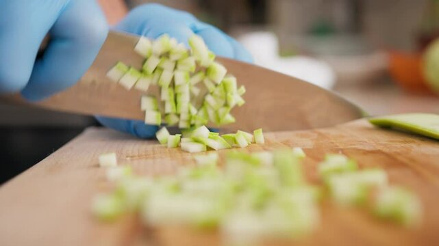 Chef Cuts Zucchini Vegetable On Brunoise Style In Restaurant Kitchen