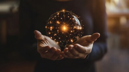 Fototapeta premium A person holds a glowing orb with interconnected lines, symbolizing technology and connection.