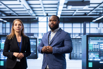 Teamworking supervisors overseeing data center after configuring network infrastructure such as...