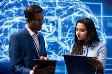 Technicians use AI cognitive computing to extract information from complex data on tablet....