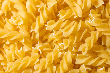 Uncooked Fusilli Pasta: A Culinary Canvas of Spiral Macaroni, Creating a Lively and Textured...