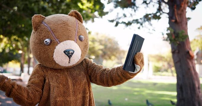 Bear costume, animal and person in city at park for selfie on walk, path and outdoor for social media. Mascot, character and influencer with suit for live streaming on web with video for post on vlog