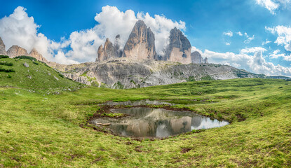 Tre Cime di Lavaredo reflecting in mountain lake, Dolomites, Italy