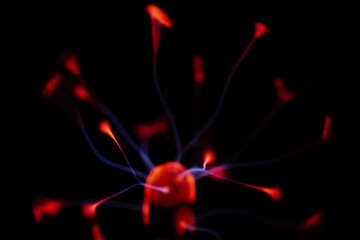 A glowing plasma ball with red and blue electric arcs radiating from its core against a dark background, creating a vivid and energetic display.