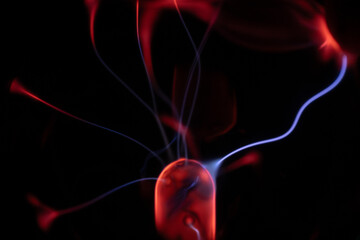 A glowing plasma ball with red and blue energy arcs radiating against a dark background, creating a...